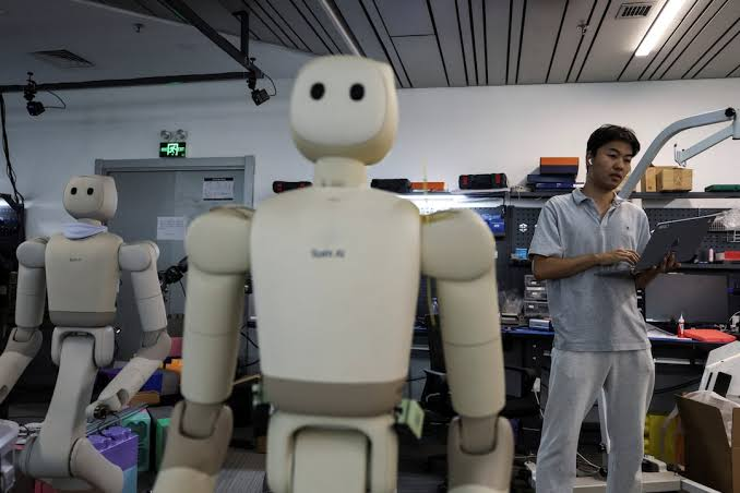 Humanoid robot learns physical tasks using artificial intelligence in a robotics laboratory